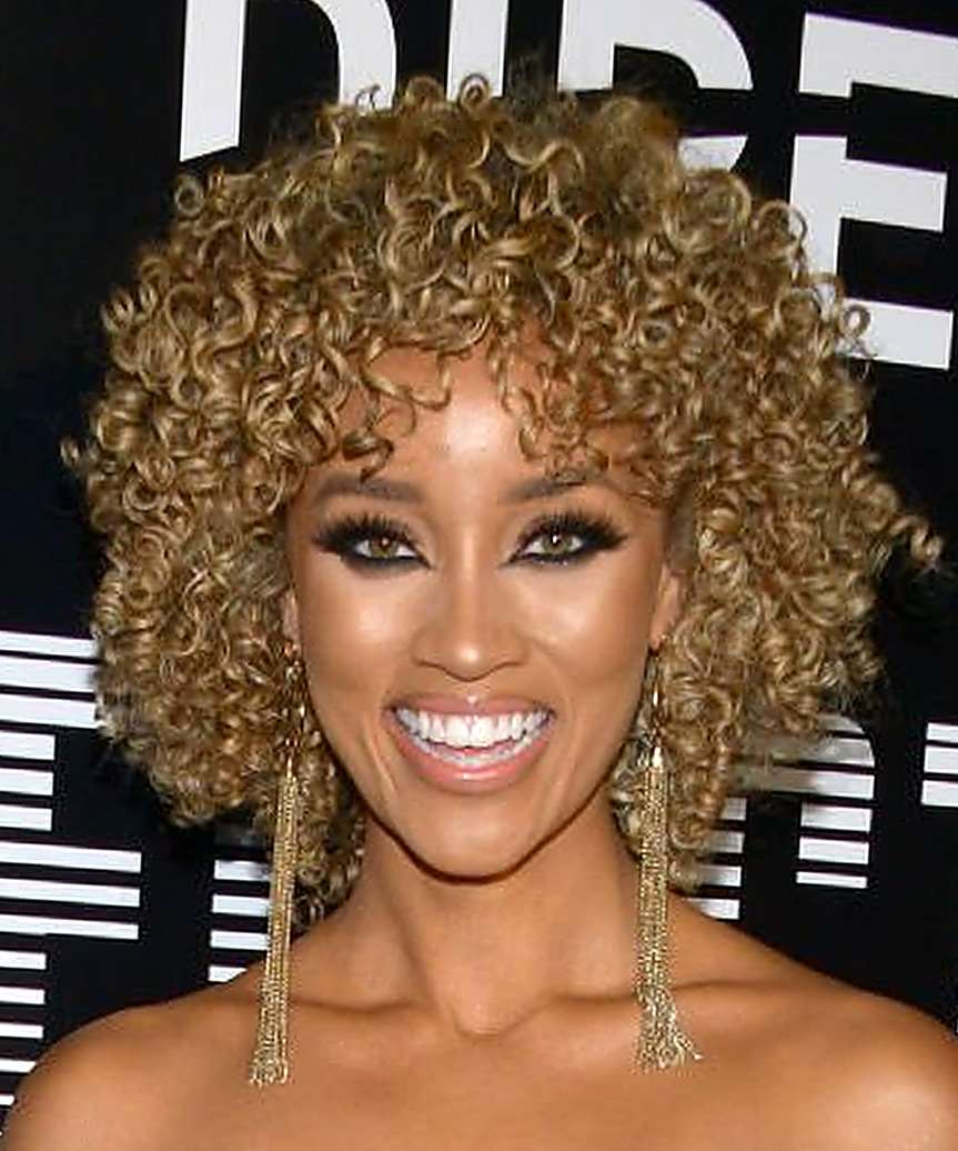 Elle Smith Medium Curly   Light Brunette  Hairstyle with Layered Bangs  and Light Blonde Highlights